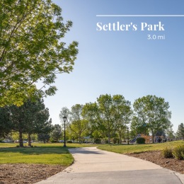 a beautiful park with many trees and a sidewalk