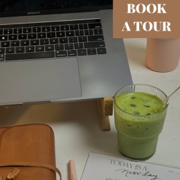a matcha tea near a laptop and a calendar