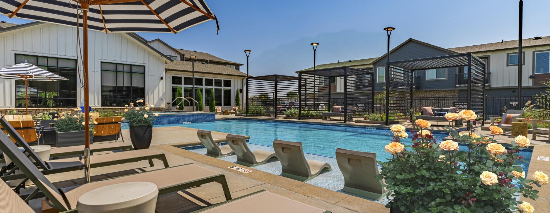 a pool with chairs and umbrellas