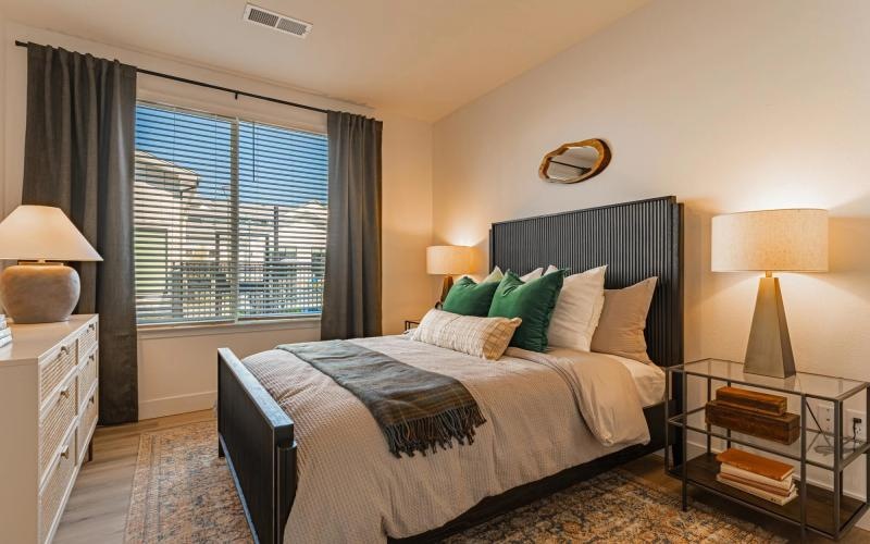 a bedroom with a bed and lamps